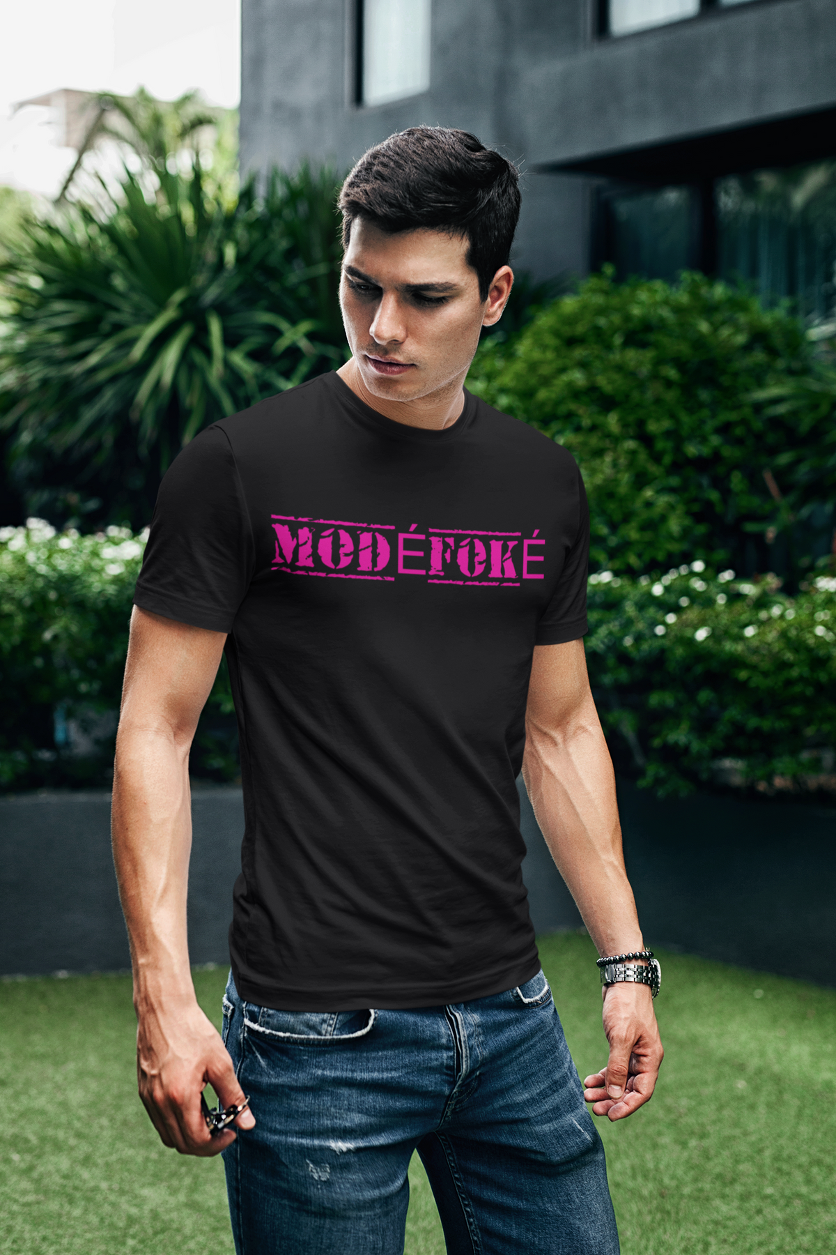 Modéfoké Graphic Tee in Black — It's Envy streetwear, worn in a garden